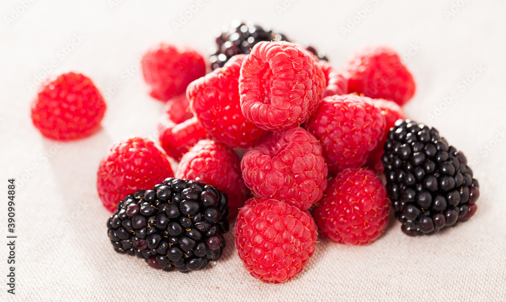 handful of fresh raspberry and blackberry berries on white background handful of fresh raspberry and blackberry berries on white background