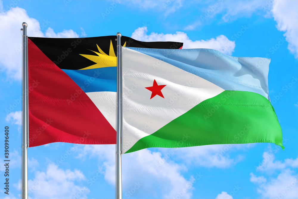 Naklejka premium Djibouti and Antigua and Barbuda national flag waving in the windy deep blue sky. Diplomacy and international relations concept.