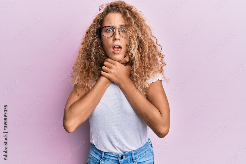 Beautiful caucasian teenager girl wearing white t-shirt over pink background shouting and suffocate because painful strangle. health problem. asphyxiate and suicide concept. Beautiful caucasian teenager girl wearing white t-shirt over pink background shouting and suffocate because painful strangle. health problem. asphyxiate and suicide concept.