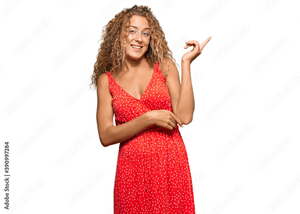 Beautiful caucasian teenager girl wearing summer dress smiling happy pointing with hand and finger to the side Beautiful caucasian teenager girl wearing summer dress smiling happy pointing with hand and finger to the side