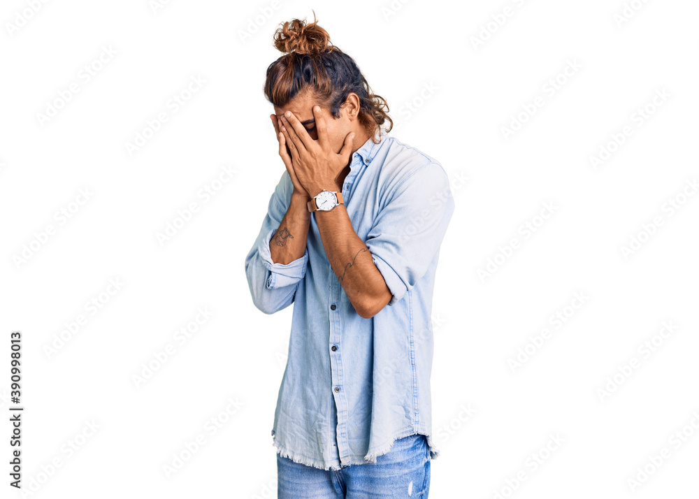 Young hispanic man wearing summer style with sad expression covering face with hands while crying. depression concept. Young hispanic man wearing summer style with sad expression covering face with hands while crying. depression concept.
