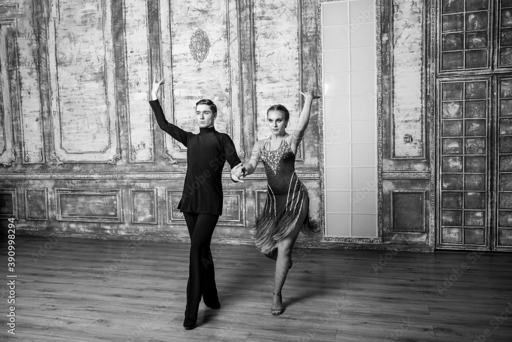 beautiful couple with dance costumes dancing latin dances in the hall beautiful couple with dance costumes dancing latin dances in the hall