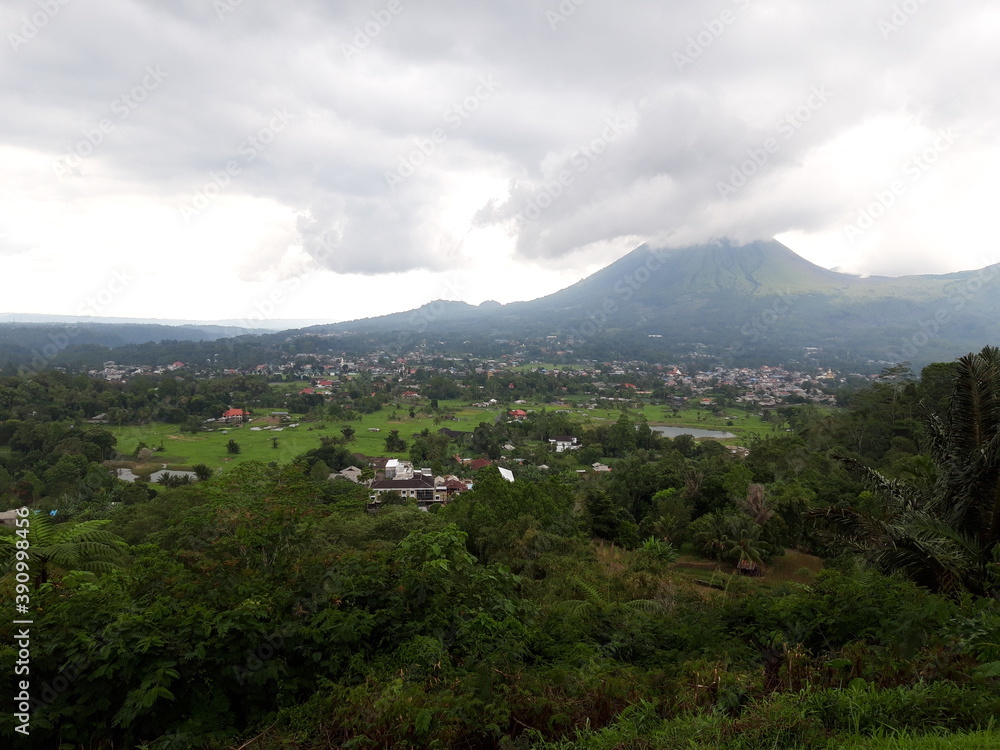 Fototapeta premium Beautiful Scenery of Countryside Village Below the Mountain at Cloudy Weather