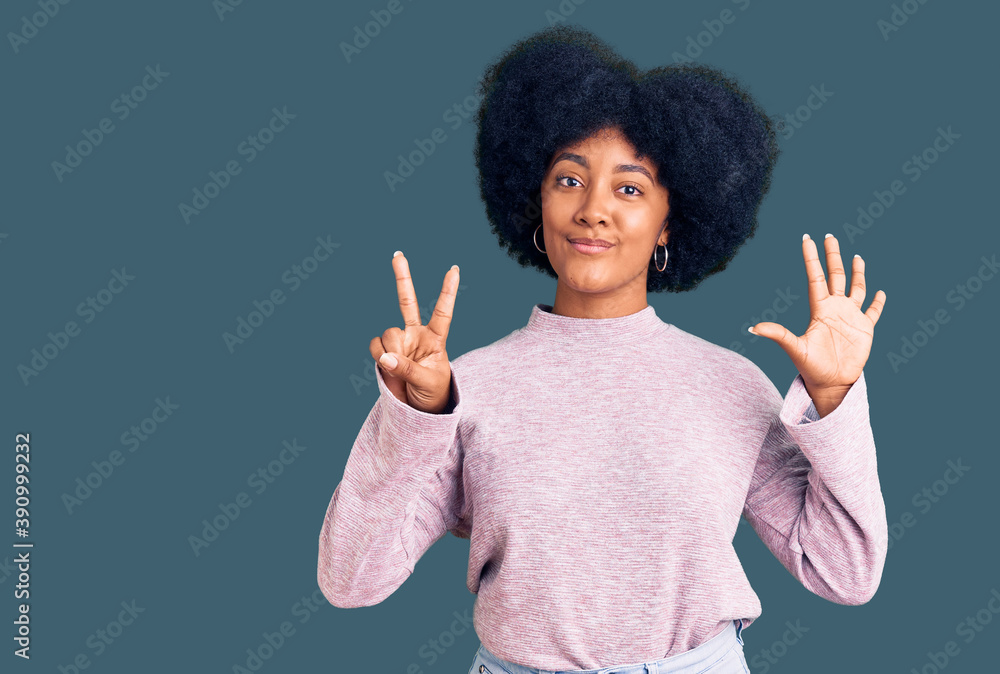Young african american girl wearing casual clothes showing and pointing up with fingers number seven while smiling confident and happy. Young african american girl wearing casual clothes showing and pointing up with fingers number seven while smiling confident and happy.
