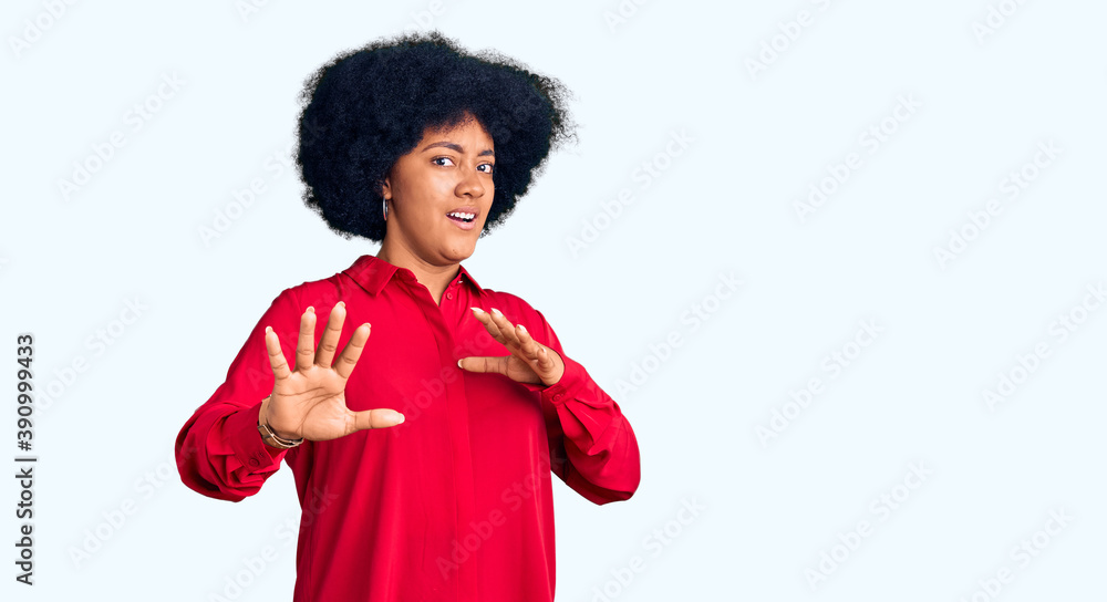 Young african american girl wearing casual clothes afraid and terrified with fear expression stop gesture with hands, shouting in shock. panic concept. Young african american girl wearing casual clothes afraid and terrified with fear expression stop gesture with hands, shouting in shock. panic concept.