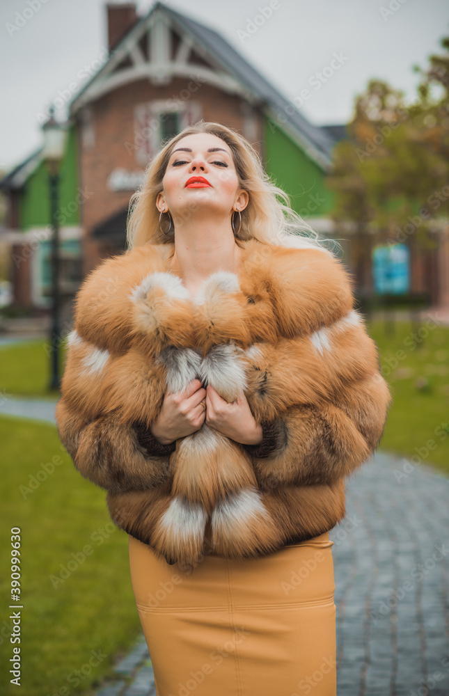 Gorgeous plus size blonde European woman in luxury fur coat, women's beauty. Concept of furs Gorgeous plus size blonde European woman in luxury fur coat, women's beauty. Concept of furs