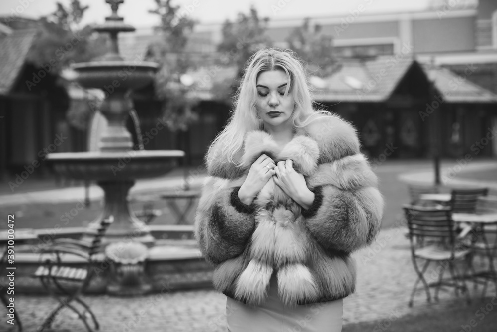Gorgeous plus size blonde European woman in luxury fur coat, women's beauty. Concept of furs Gorgeous plus size blonde European woman in luxury fur coat, women's beauty. Concept of furs