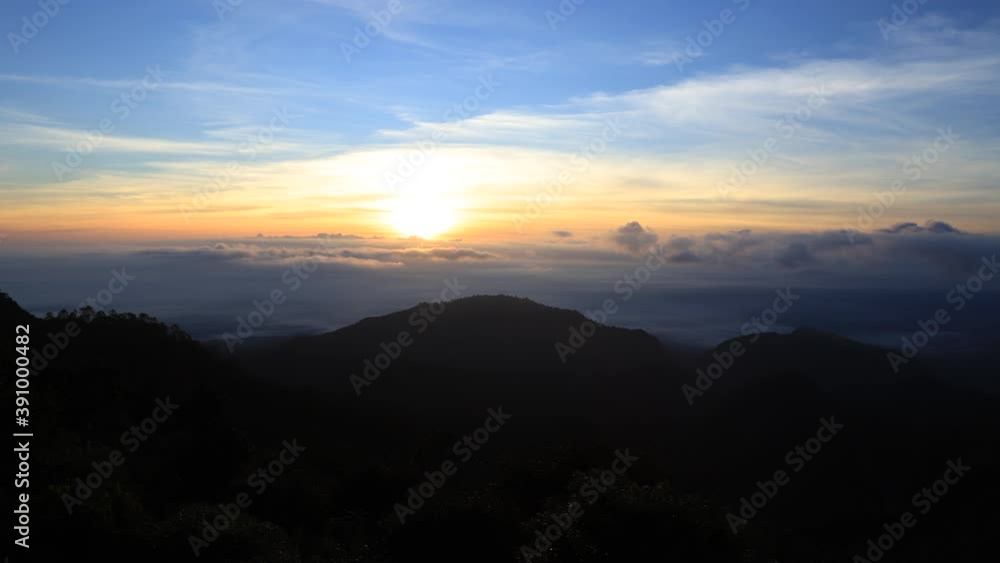 Beautiful orange and blue sky of sunrise over the mountains on morning and movement of fluffy clouds with sun rays and lens flare, Time lapse 4K Beautiful orange and blue sky of sunrise over the mountains on morning and movement of fluffy clouds with sun rays and lens flare, Time lapse 4K