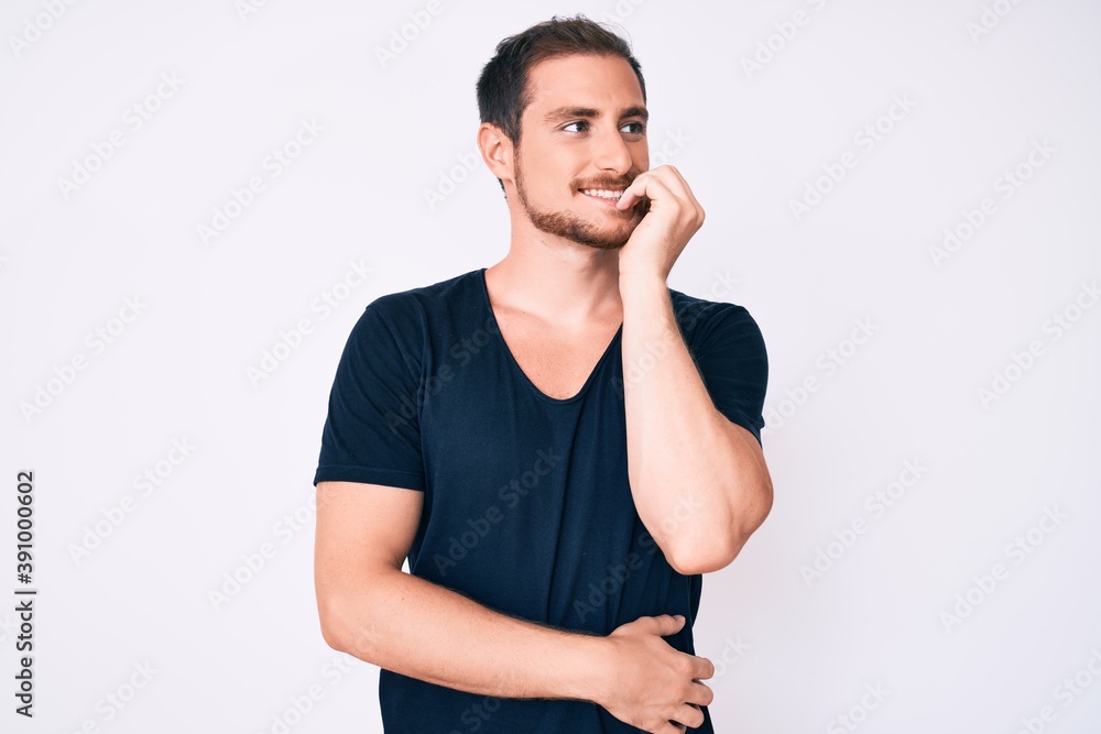 Young handsome man wearing casual clothes looking stressed and nervous with hands on mouth biting nails. anxiety problem. Young handsome man wearing casual clothes looking stressed and nervous with hands on mouth biting nails. anxiety problem.