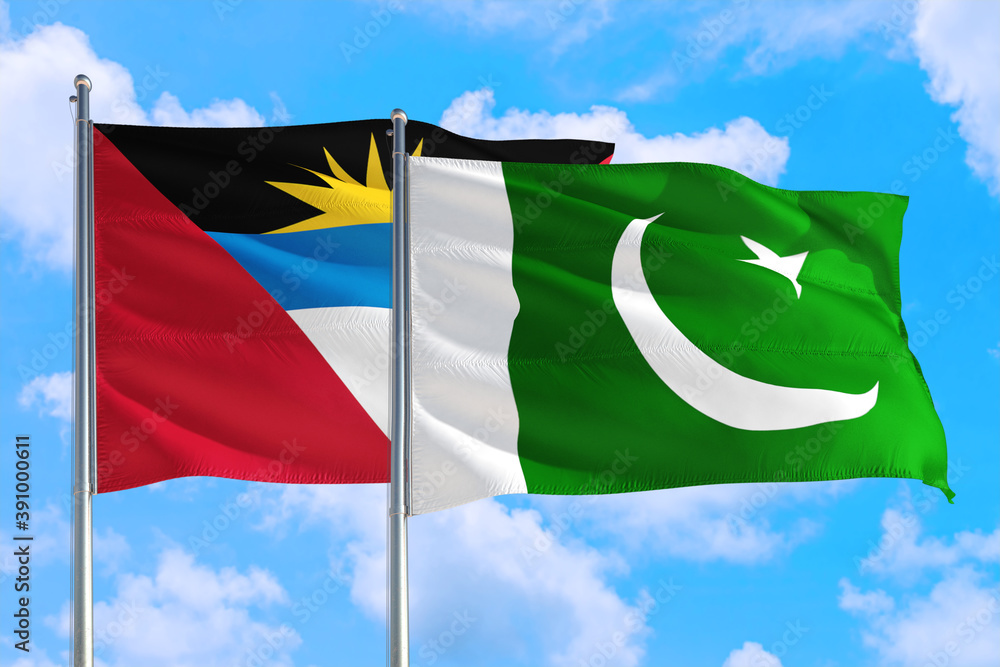 Pakistan and Antigua and Barbuda national flag waving in the windy deep blue sky. Diplomacy and international relations concept. Pakistan and Antigua and Barbuda national flag waving in the windy deep blue sky. Diplomacy and international relations concept.