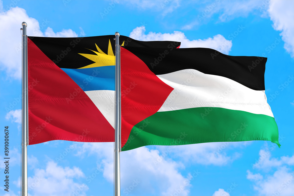 Palestine and Antigua and Barbuda national flag waving in the windy deep blue sky. Diplomacy and international relations concept. Palestine and Antigua and Barbuda national flag waving in the windy deep blue sky. Diplomacy and international relations concept.