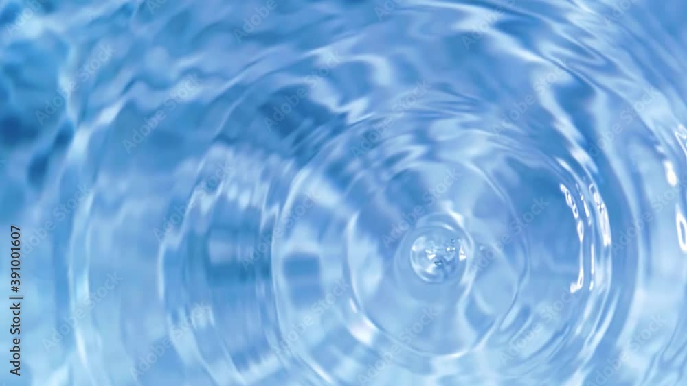 Top view slow motion of drop falling into the water surface and diverging circles on white background Top view slow motion of drop falling into the water surface and diverging circles on white background