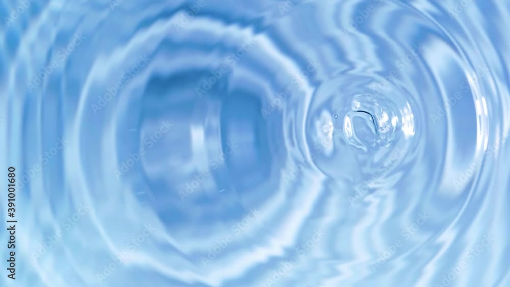 Top view slow motion of drop falling into the water surface and diverging circles on white background Top view slow motion of drop falling into the water surface and diverging circles on white background