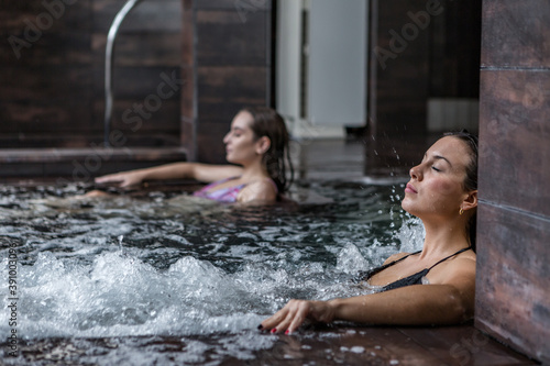 Serene woman in bubbling tub in spa