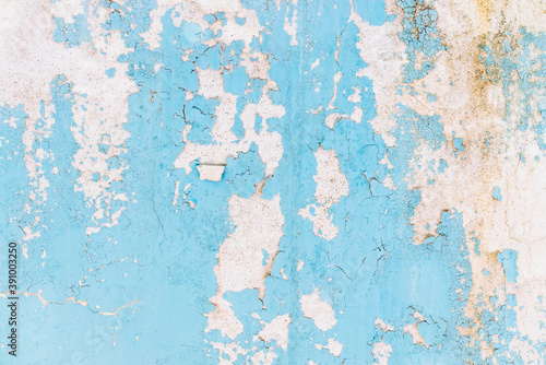 Blue peeling paint, mold and crack on the old concrete wall.
