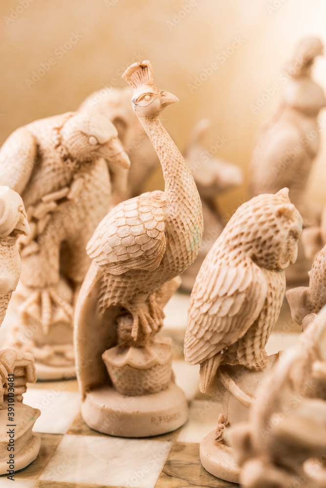 Obraz premium Сhess as an abstract concept. Beautiful antique chess set on marble chess board.