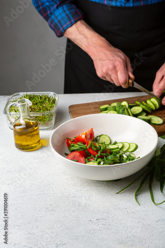 Man preparing green vegan salad
