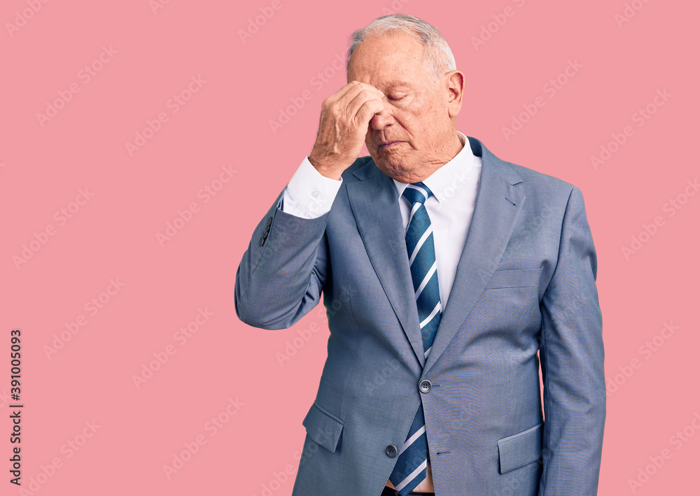 Senior handsome grey-haired man wearing elegant suit tired rubbing nose and eyes feeling fatigue and headache. stress and frustration concept. Senior handsome grey-haired man wearing elegant suit tired rubbing nose and eyes feeling fatigue and headache. stress and frustration concept.