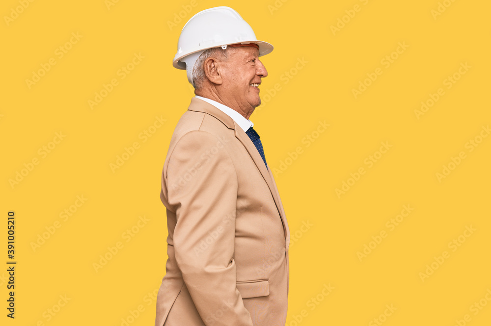 Senior caucasian man wearing architect hardhat looking to side, relax profile pose with natural face with confident smile. Senior caucasian man wearing architect hardhat looking to side, relax profile pose with natural face with confident smile.