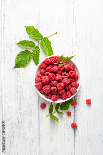 Overhead view of raspberry on white wooden surface