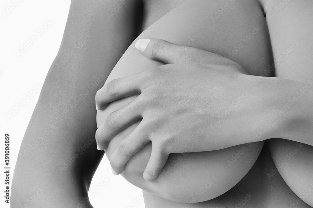 Woman with big bust covers her breast black and white Woman with big bust covers her breast black and white