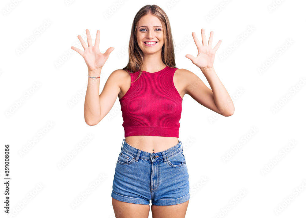 Young beautiful blonde woman wearing elegant summer shirt showing and pointing up with fingers number ten while smiling confident and happy.