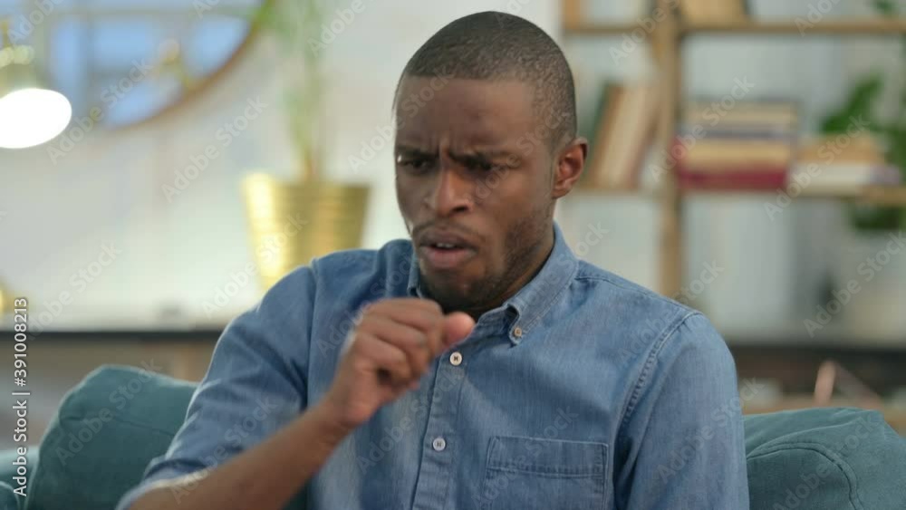 Sick Young African Man Coughing at Home Sick Young African Man Coughing at Home