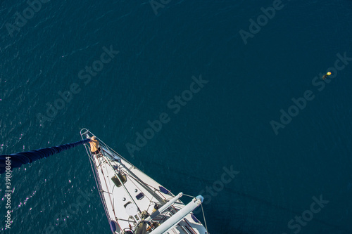 The Luxury Yacht View from Above. Blue and deep ocean. The man is standing on the board.