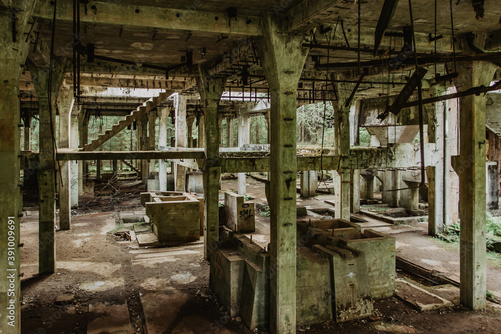 View of abandoned empty buildings of old tin mine. Industrial dirty building interior. Damaged factory in Rolava, Ore mountains,Czech republic
