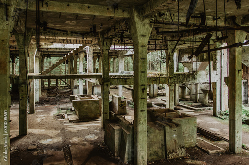 View of abandoned empty buildings of old tin mine. Industrial dirty building interior. Damaged factory in Rolava, Ore mountains,Czech republic