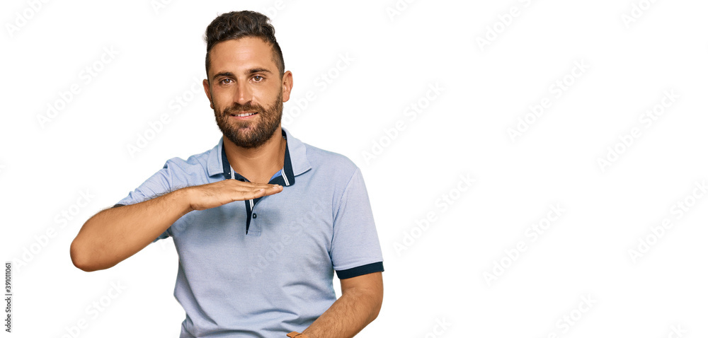 Handsome man with beard wearing casual clothes gesturing with hands showing big and large size sign, measure symbol. smiling looking at the camera. measuring concept. Handsome man with beard wearing casual clothes gesturing with hands showing big and large size sign, measure symbol. smiling looking at the camera. measuring concept.