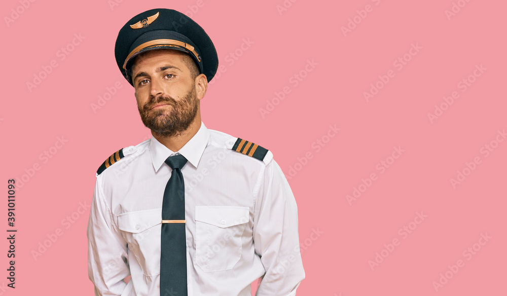 Handsome man with beard wearing airplane pilot uniform depressed and worry for distress, crying angry and afraid. sad expression.