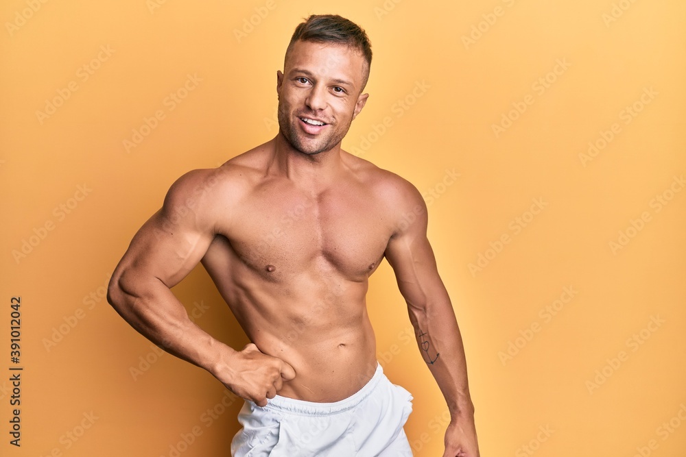 Handsome bodybuldier man posing sexy showing muscle, shirtless torso showing pectorals and sixpack Handsome bodybuldier man posing sexy showing muscle, shirtless torso showing pectorals and sixpack