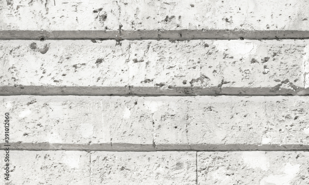 Fototapeta premium A solid wall of rough gray cement, with regular recessed areas. Perfect neutral backdrop. 