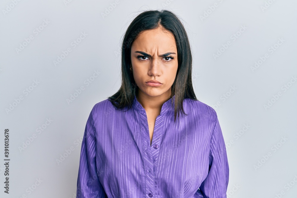 Young brunette woman wearing casual clothes skeptic and nervous, frowning upset because of problem. negative person. Young brunette woman wearing casual clothes skeptic and nervous, frowning upset because of problem. negative person.