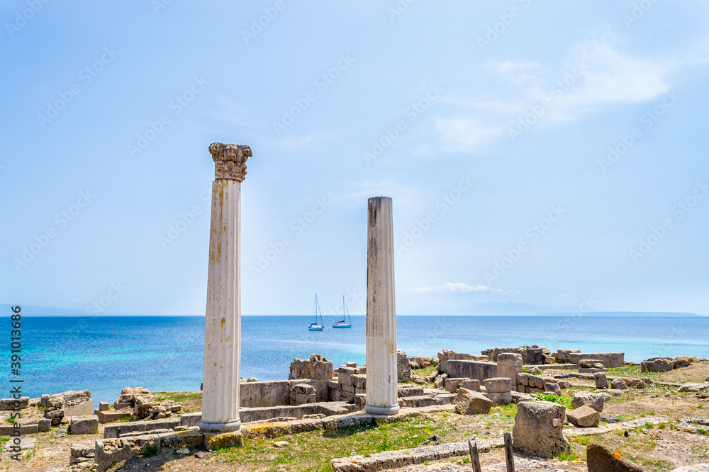 Famous Tharros columns with a blue sea on the background