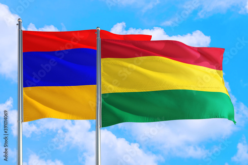Bolivia and Armenia national flag waving in the windy deep blue sky. Diplomacy and international relations concept.