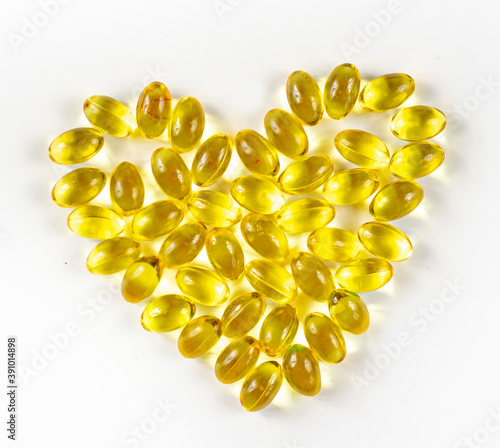 Fish oil from cod liver in capsules for children and adults in the form of a heart on a white background, prevention,