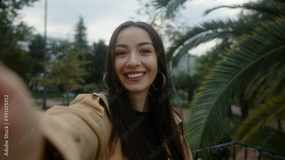 Beautiful young smiling face woman holding camera or phone in hand and she makes video call or she is recording video for her fans, she is surprised suddenly, video call and vlogger concept Beautiful young smiling face woman holding camera or phone in hand and she makes video call or she is recording video for her fans, she is surprised suddenly, video call and vlogger concept