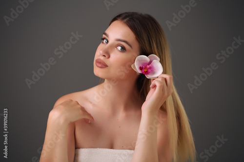 Woman holds beauty flower. skin care treatment