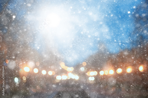 abstract snow blurred background city lights, winter holiday new year