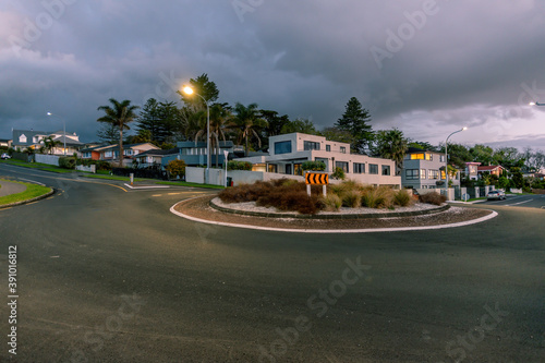 AUCKLAND, NEW ZEALAND - Sep 15, 2019: roundabout next to Macleans college with suburban houses in background in evening light photo