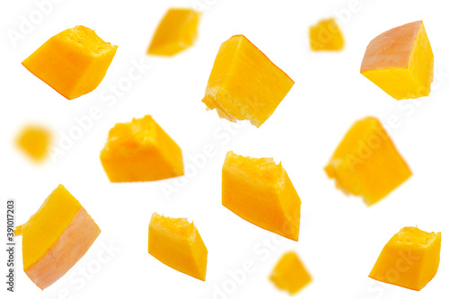 Falling pumpkin slices isolated on a white background, selective focus. Set of pumpkin slices in the air. Pumpkin slices fall. Pumpkin slices in the air on a white background.