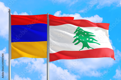 Lebanon and Armenia national flag waving in the windy deep blue sky. Diplomacy and international relations concept.