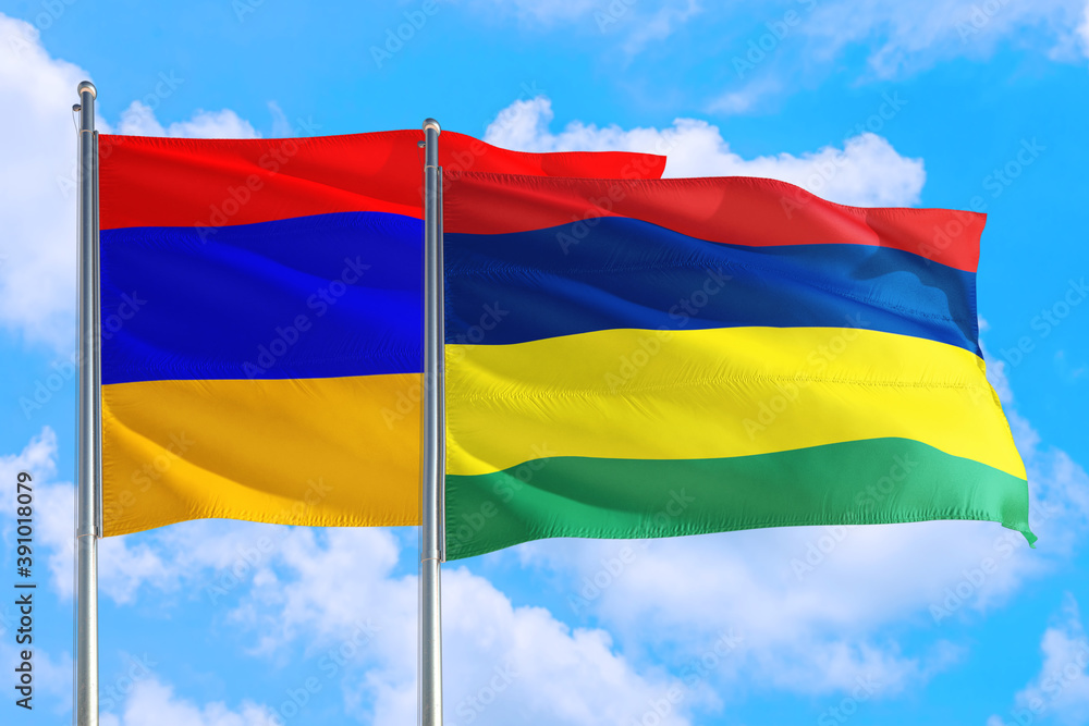 Mauritius and Armenia national flag waving in the windy deep blue sky. Diplomacy and international relations concept. Mauritius and Armenia national flag waving in the windy deep blue sky. Diplomacy and international relations concept.
