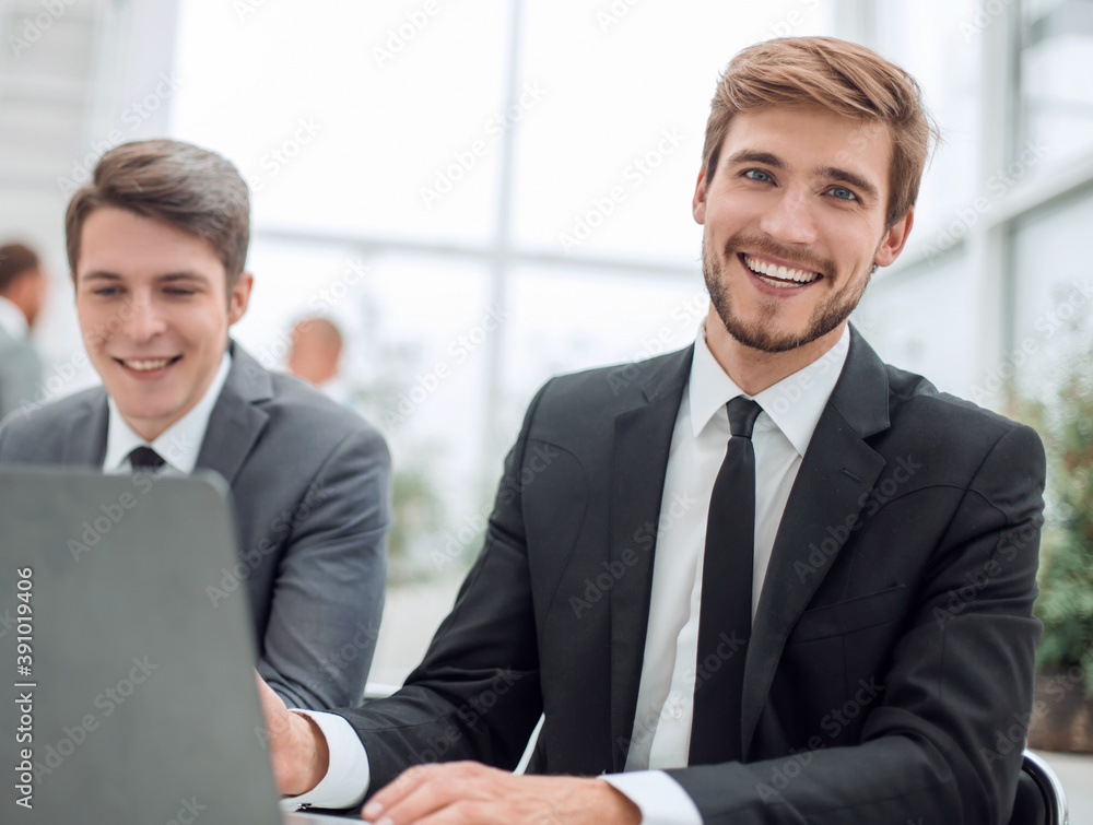 close up. two business men sitting at an office Desk close up. two business men sitting at an office Desk