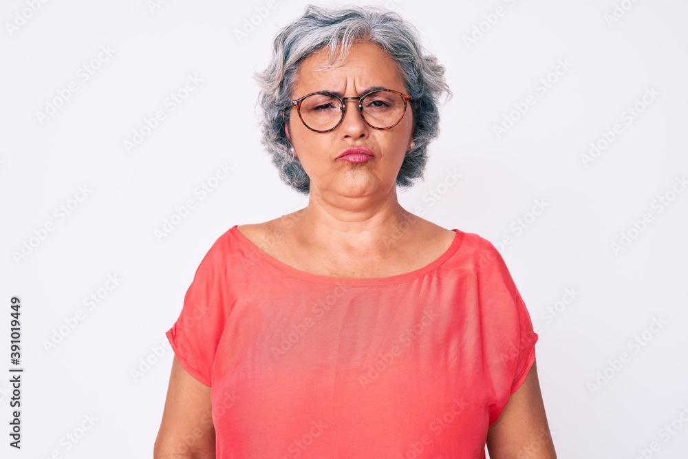 Senior hispanic grey- haired woman wearing casual clothes and glasses depressed and worry for distress, crying angry and afraid. sad expression. Senior hispanic grey- haired woman wearing casual clothes and glasses depressed and worry for distress, crying angry and afraid. sad expression.
