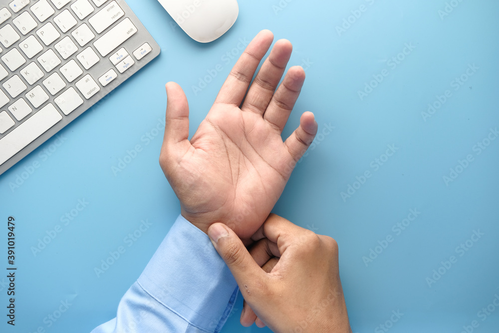  Young man in suffering wrist pain, close up 