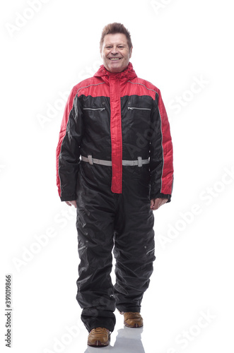 man in a winter insulated jumpsuit reading walking forward © ASDF