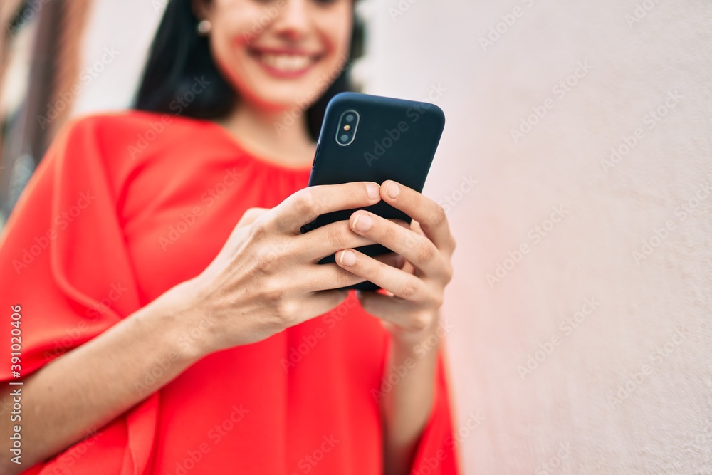 Young latin girl smiling happy using smartphone at the city. Young latin girl smiling happy using smartphone at the city.